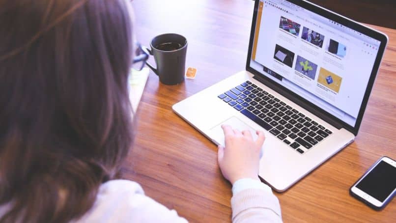 mujer laptop mesa taza